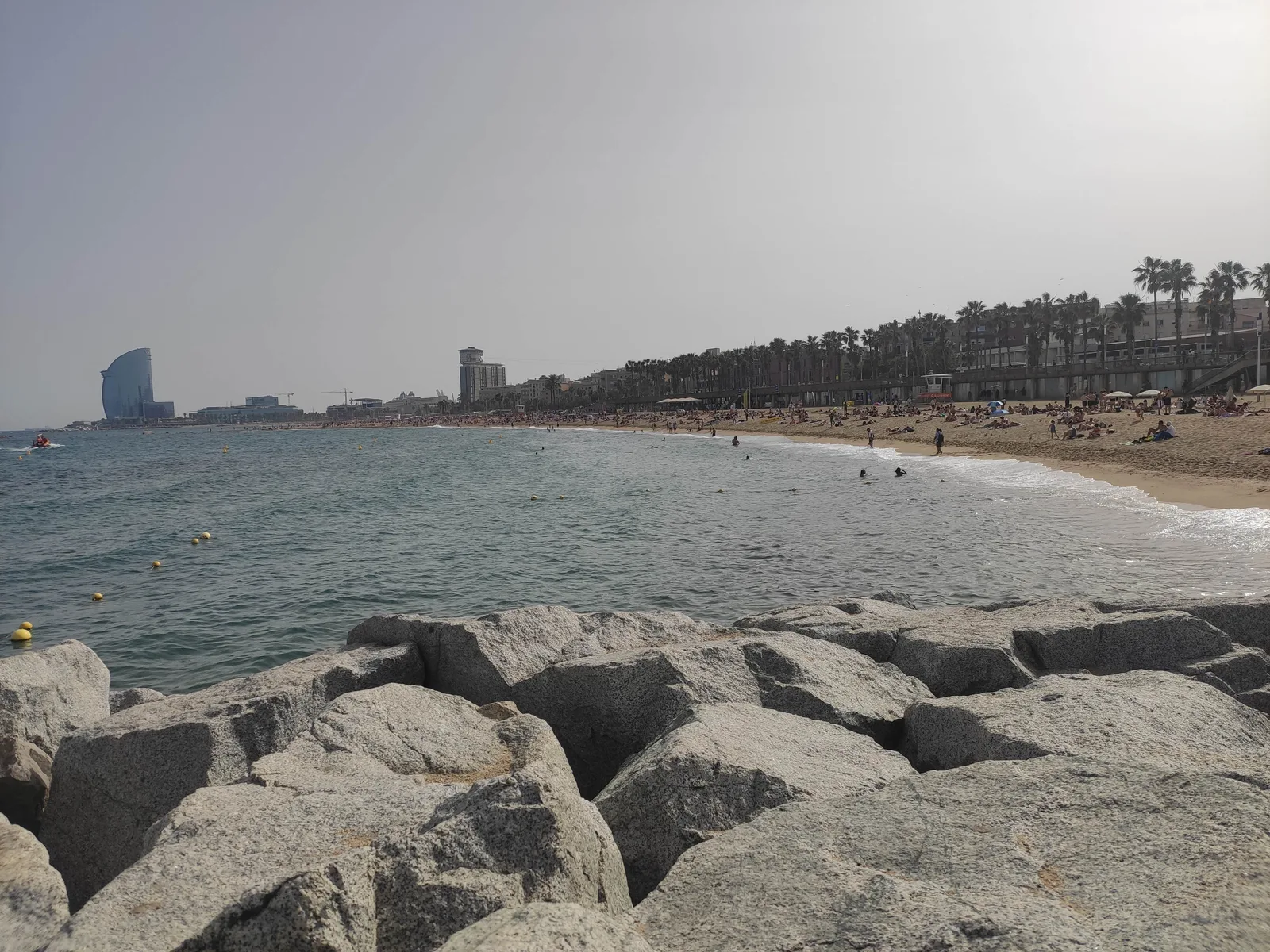 Crowds on Barceloneta Beach in Barcelona during summer