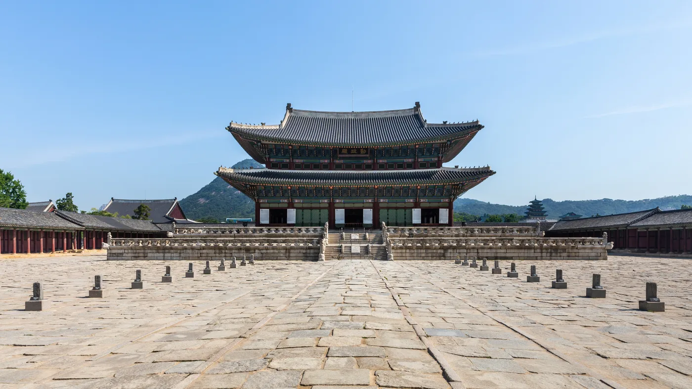 Geunjeongjeon throne hall at Gyeongbokgung Palace in Seoul under a blue sky