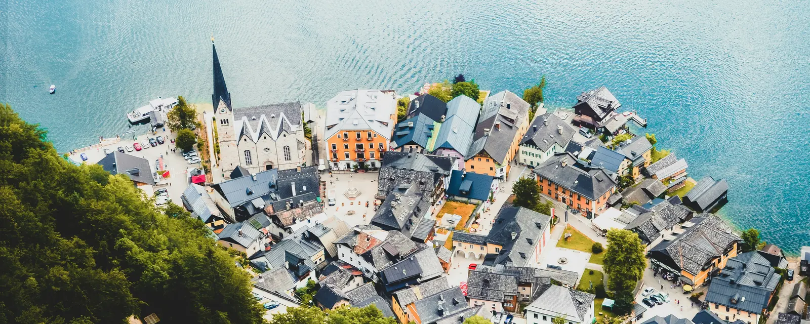 Hallstatt's lakeside church and colorful village beside Lake Hallstatt, Austria