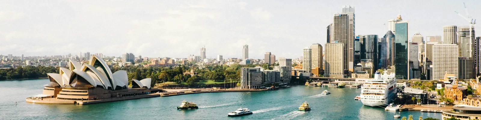 Sydney Opera House beside the blue waters of Sydney Harbour
