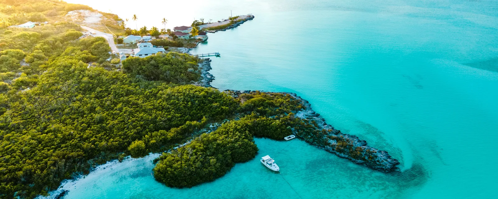 A green island and sheltered turquoise cove in Exuma, The Bahamas