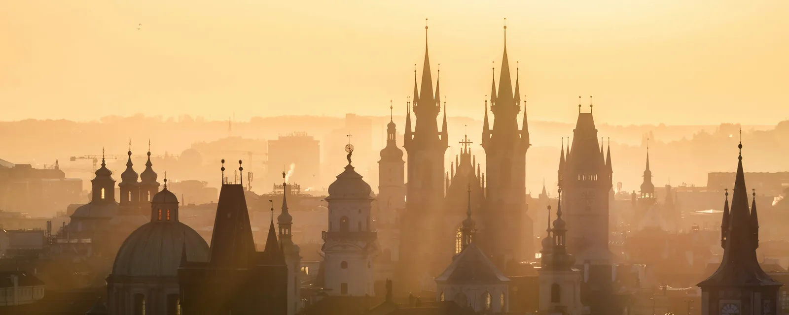 Prague's old-town church spires in golden morning light, Czechia