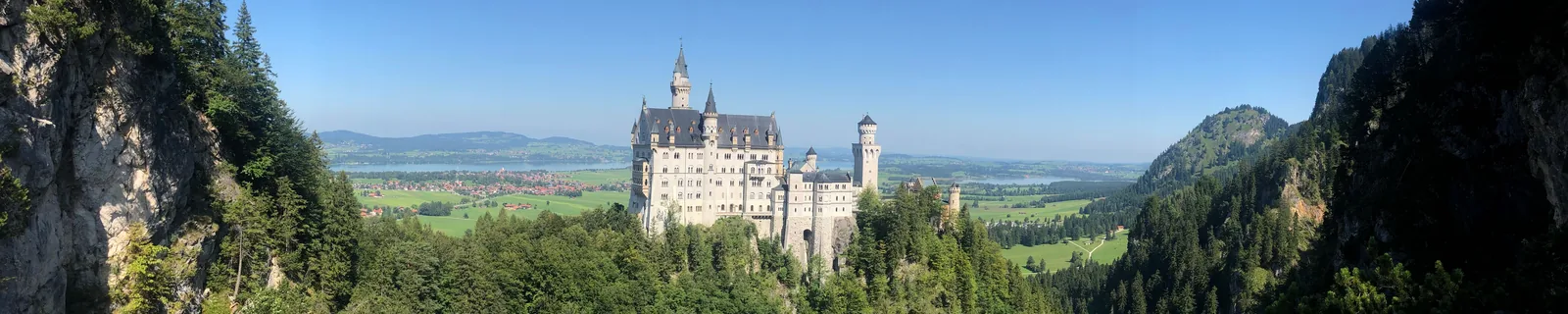 Neuschwanstein Castle above the forested valley in Schwangau, Germany