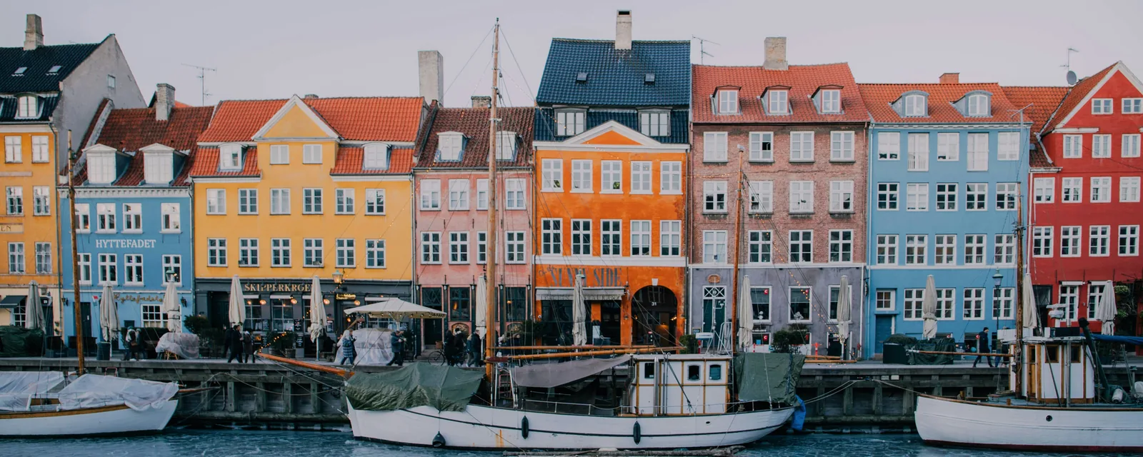 Colorful Nyhavn waterfront and moored boats in Copenhagen, Denmark
