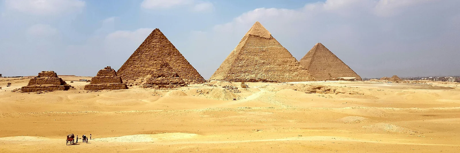 The Pyramids of Giza across the golden desert in Egypt