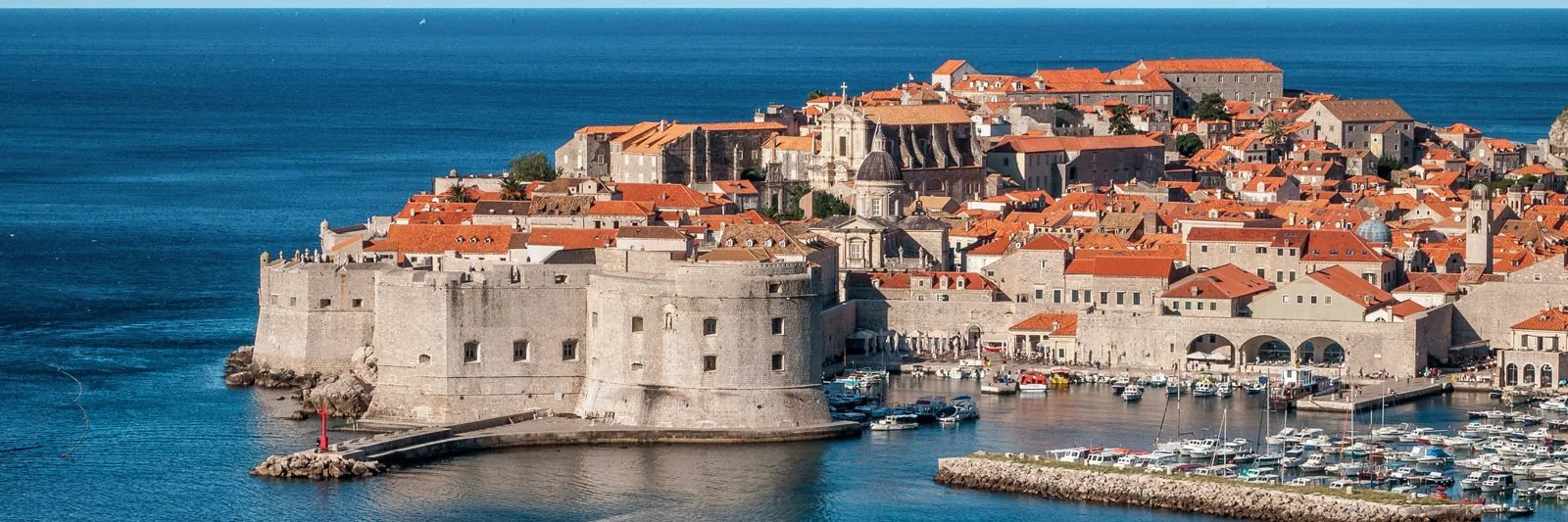 Dubrovnik's stone harbour fort and red-roofed old town, Croatia
