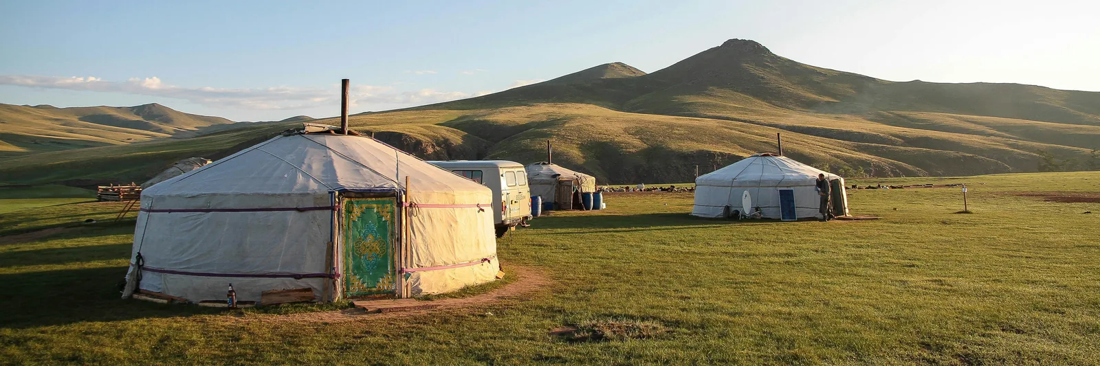 Traditional Mongolian ger tents on the open steppe at sunrise