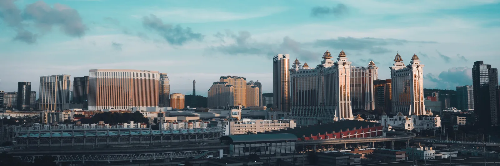 Galaxy Macau towers and the Cotai skyline beneath a blue sky