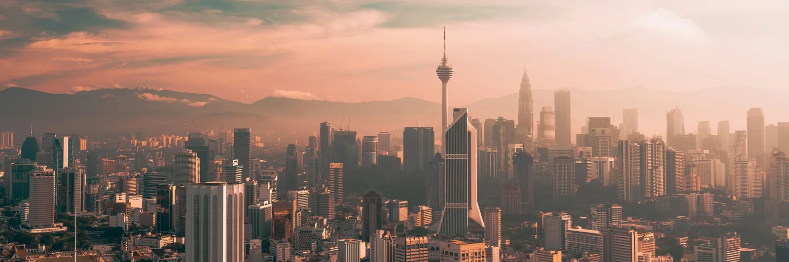 KL Tower above Kuala Lumpur's skyline in warm evening light