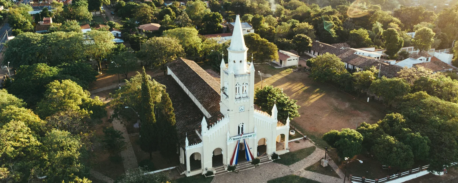 A white church and leafy surrounding streets in Aregua, Paraguay