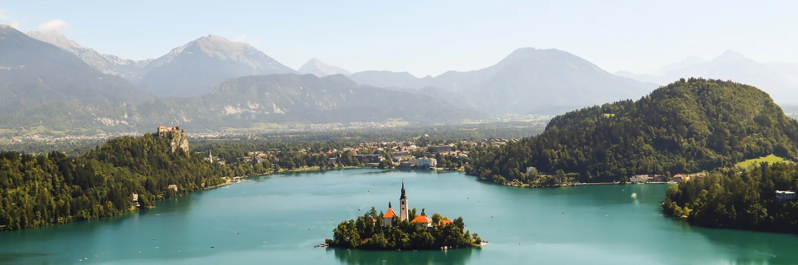 Lake Bled island church, castle and Alpine backdrop, Slovenia