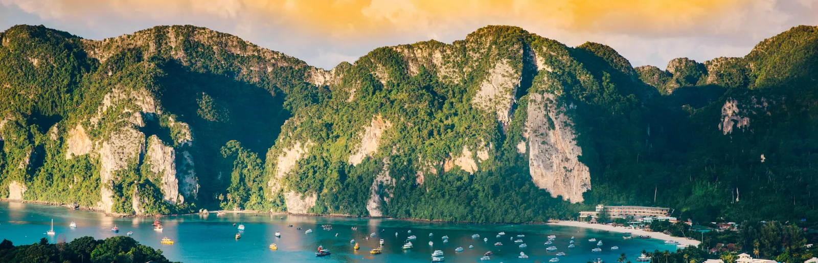 Limestone cliffs and boats on turquoise water in the Phi Phi Islands, Thailand