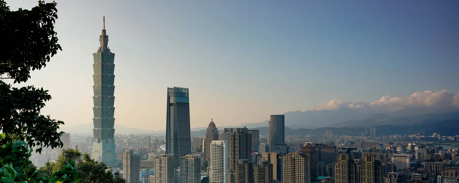 Taipei 101 rising above the city skyline and green Elephant Mountain foreground, Taiwan