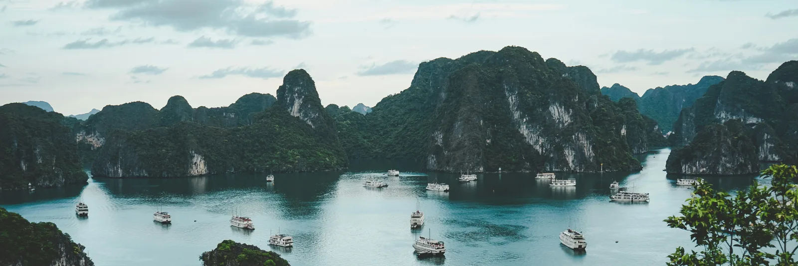 Cruise boats among the limestone islands of Ha Long Bay, Vietnam