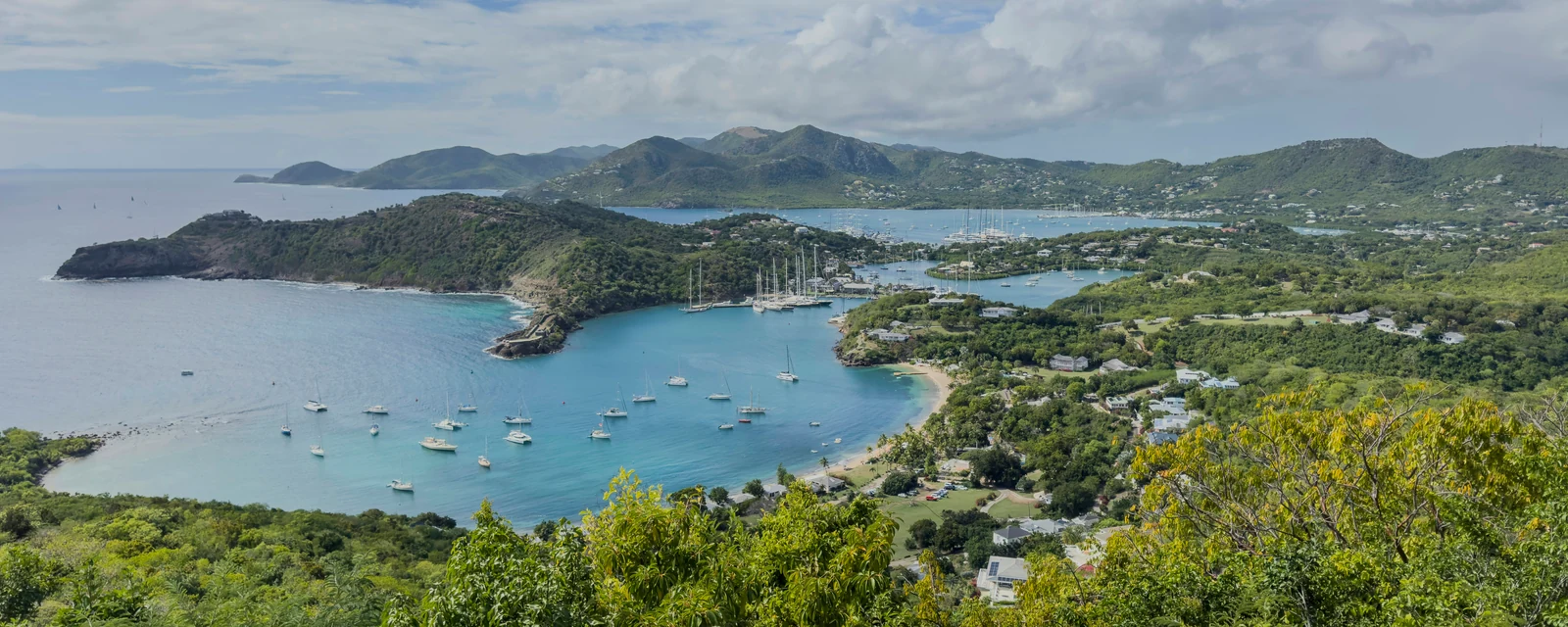 English Harbour and green headlands above turquoise water in Antigua
