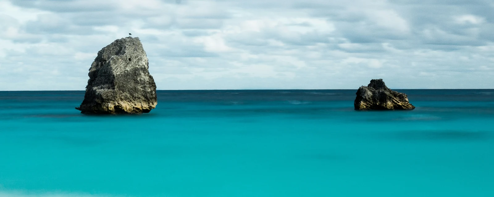 Limestone sea stacks rising from turquoise water at Warwick Long Bay, Bermuda