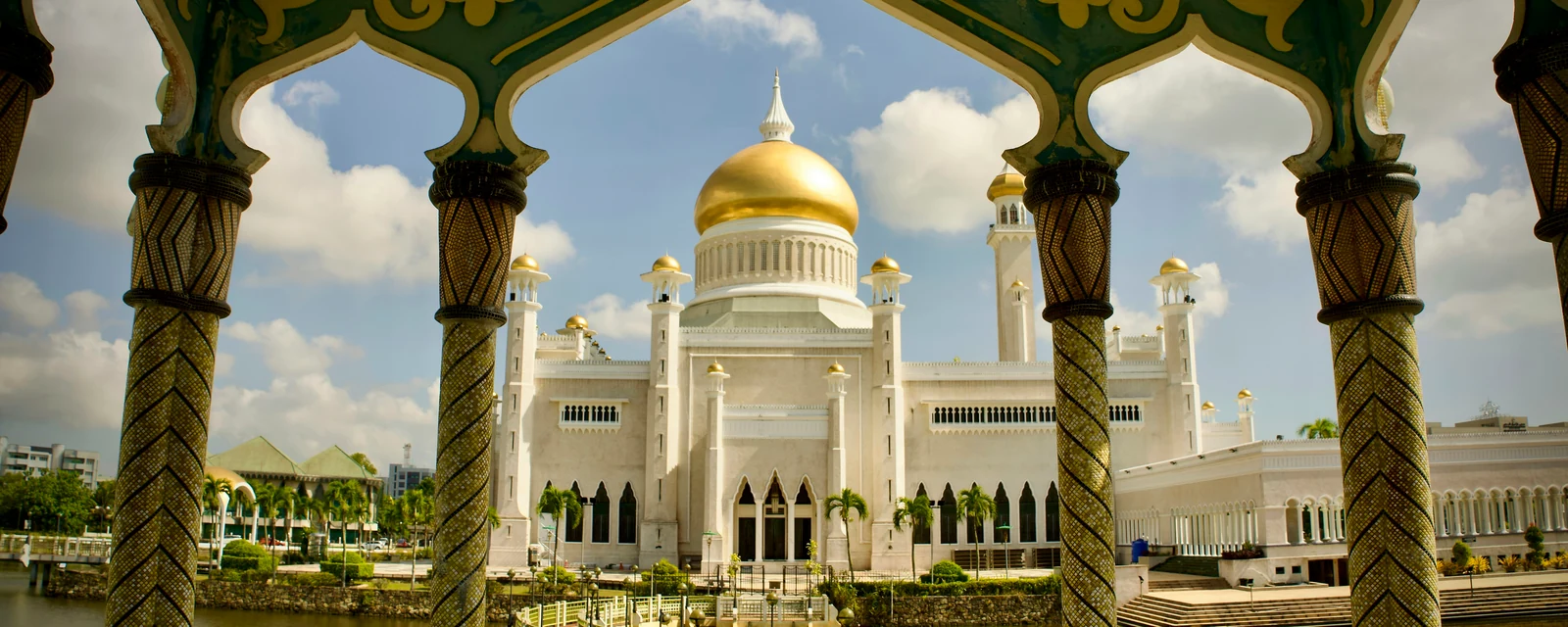 Golden dome of Omar Ali Saifuddien Mosque framed by ornate arches in Brunei
