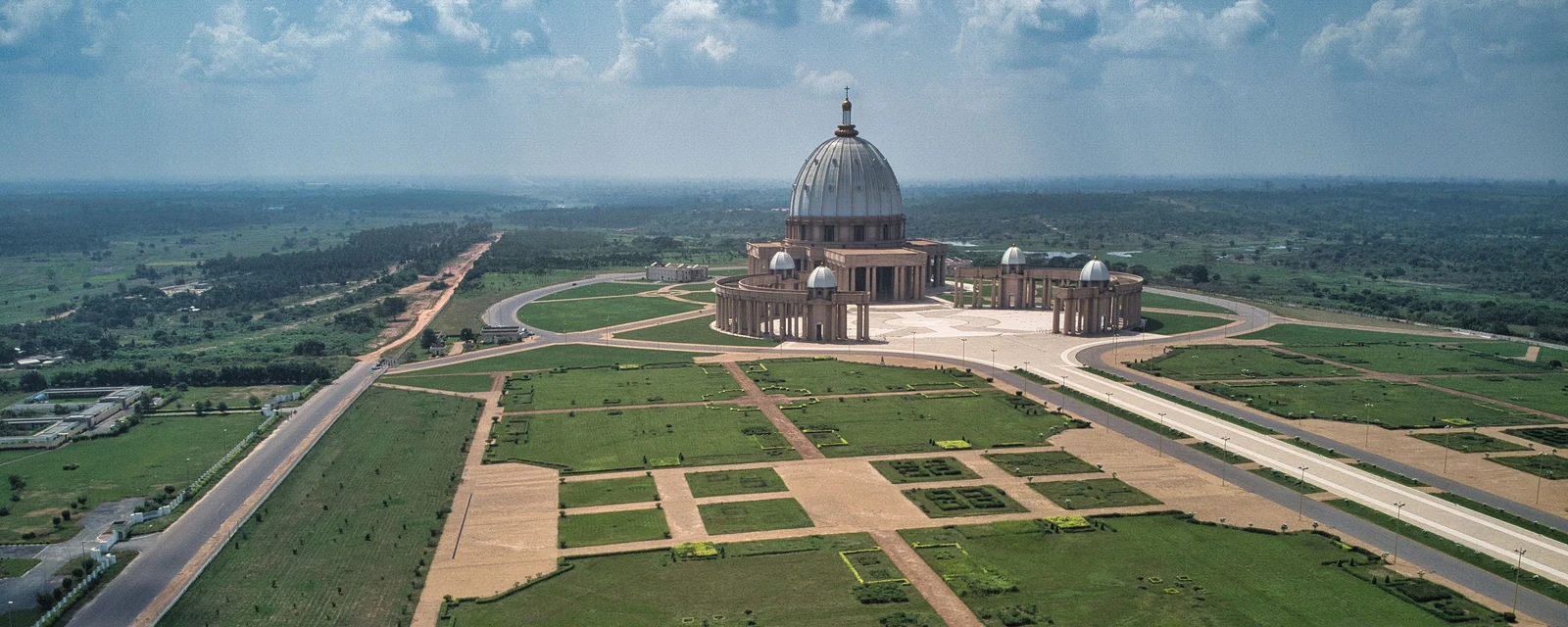 Aerial view of the complete Basilica of Our Lady of Peace and formal gardens in Yamoussoukro, Cรดte dโIvoire