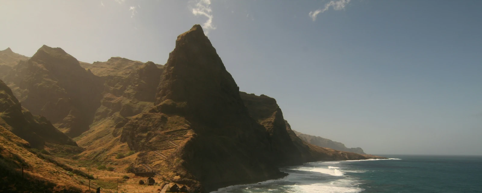Sunlit cliffs and Atlantic surf along the Formiguinhas coast on Santo Antão