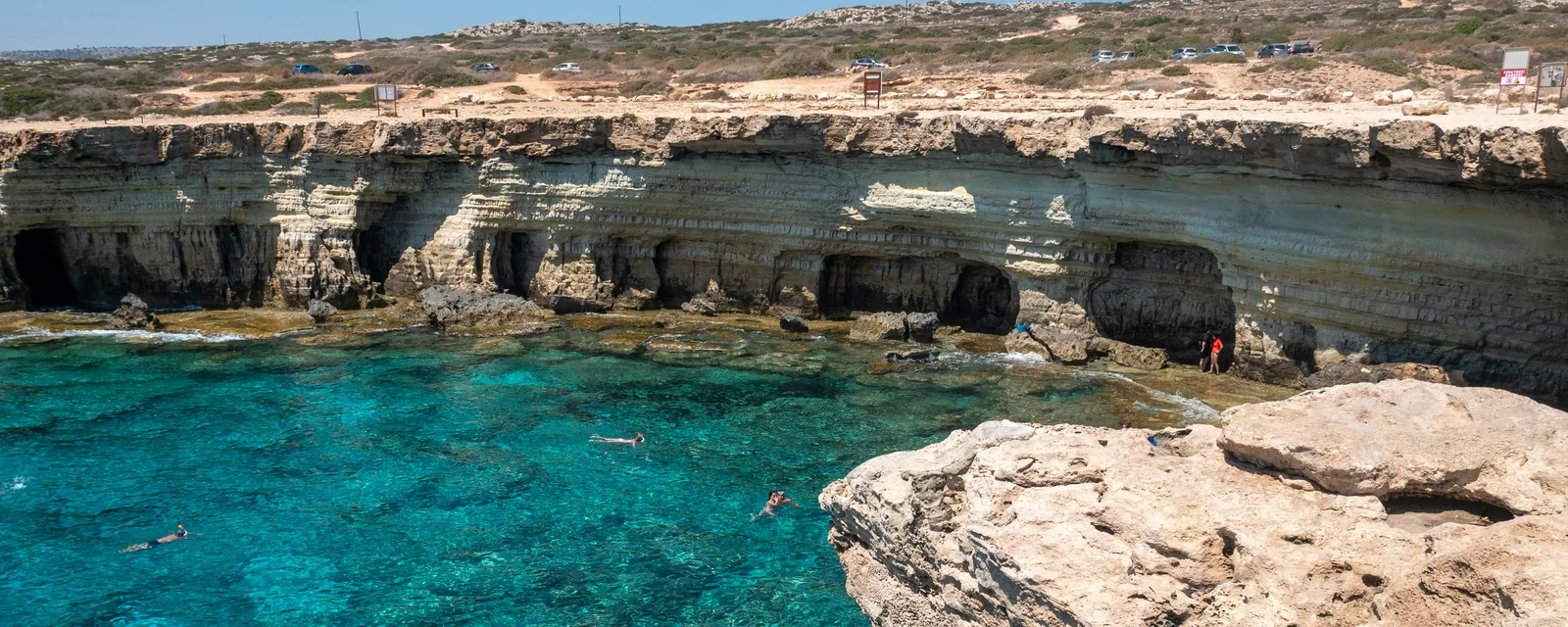 Turquoise water beneath limestone sea caves on the coast of Cyprus