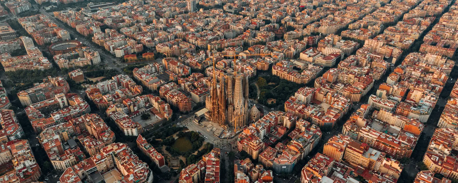 Aerial view of the Sagrada Família and Barcelona’s sunlit city blocks, Spain