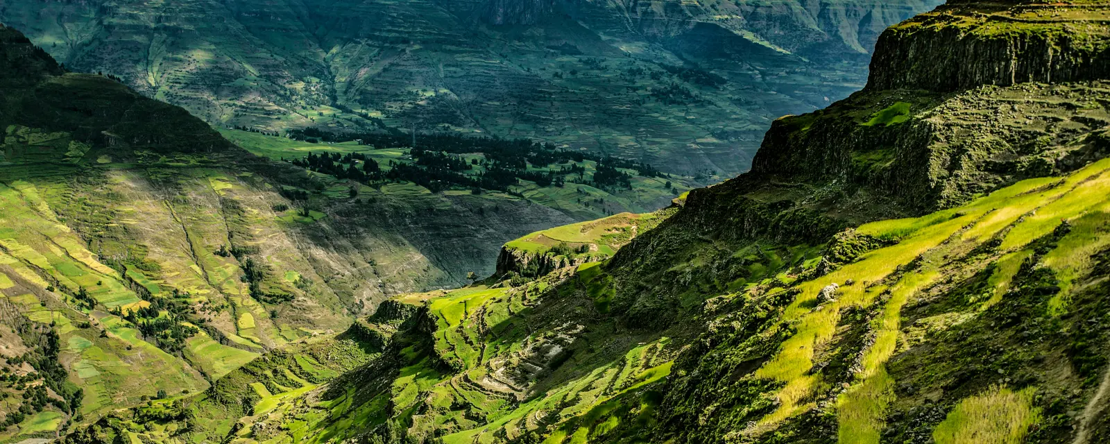 Green mountain slopes and winding paths on the journey toward Abune Yosef in Ethiopia