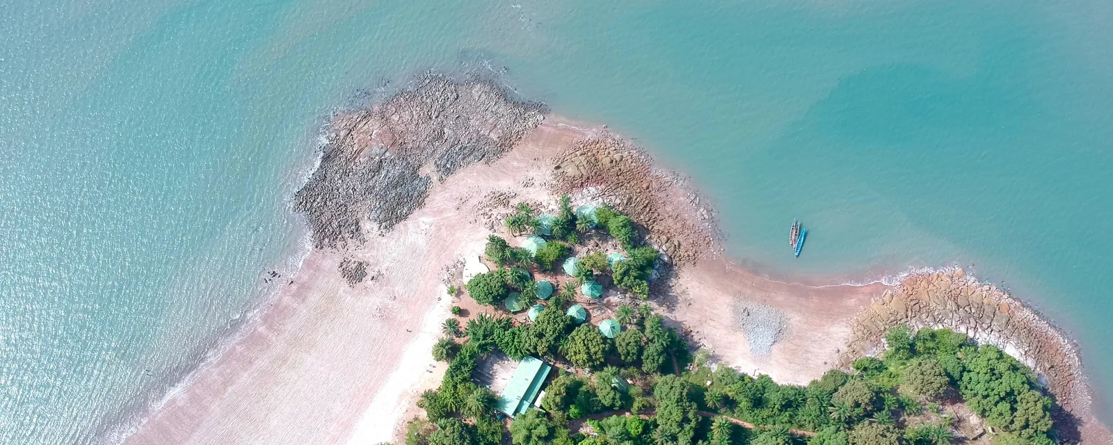 Turquoise water and a palm-fringed cove on the coast of Kaloum, Guinea
