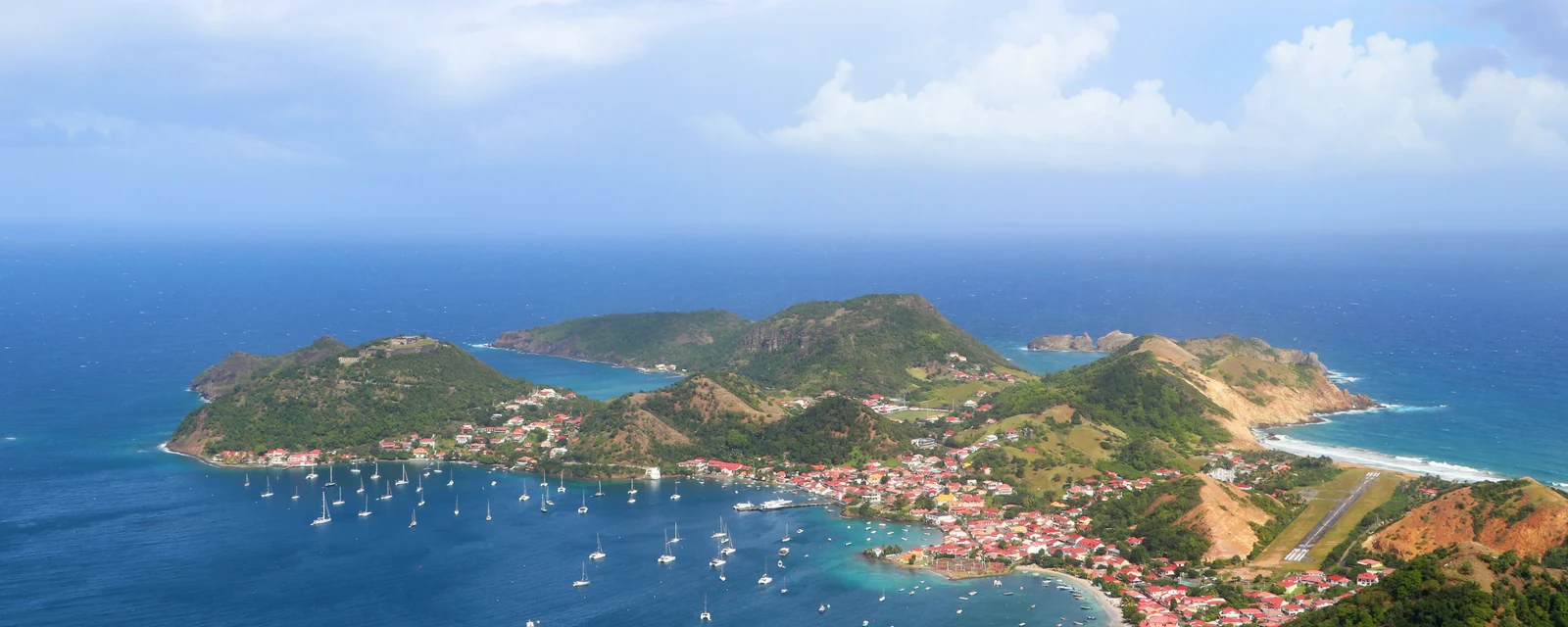 The curved bay and green hills of Terre-de-Haut in Les Saintes, Guadeloupe