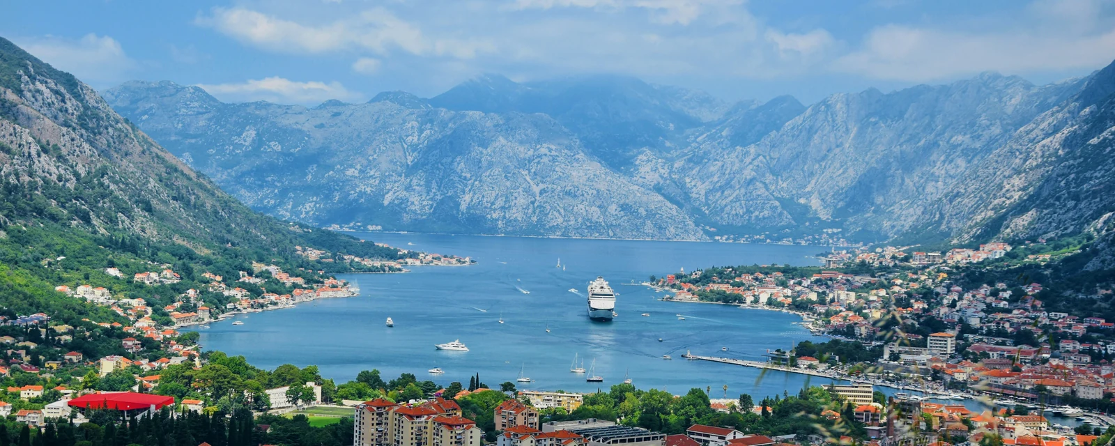 The blue Bay of Kotor framed by mountains and terracotta rooftops in Montenegro