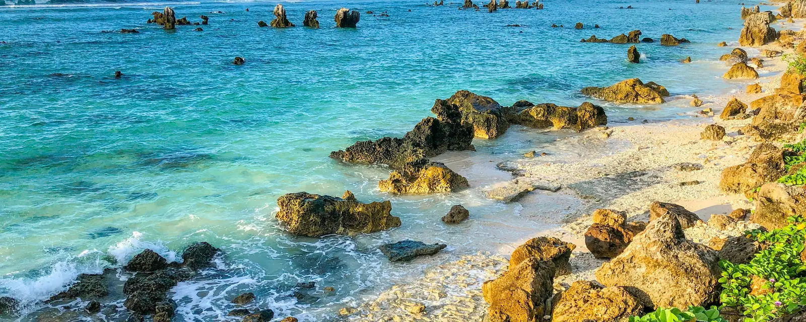 Turquoise Pacific water and sculptural coastal rocks in Nauru