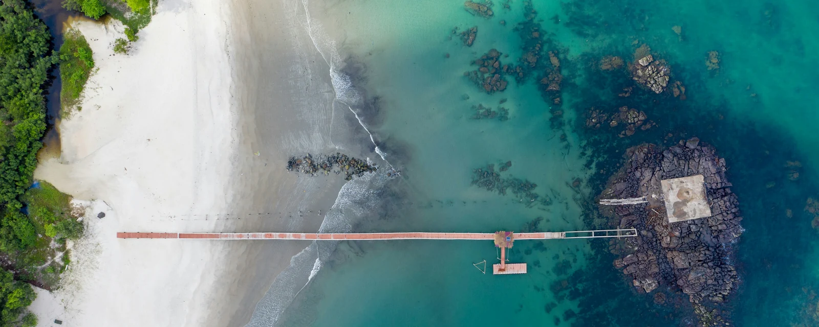 Aerial view of white sand and turquoise water at Tokeh, Sierra Leone
