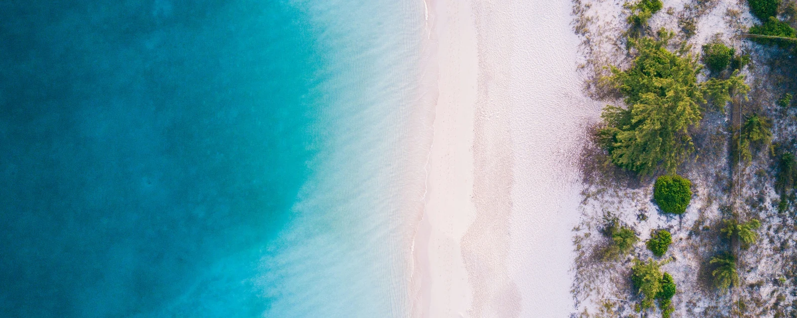 Clear turquoise sea meeting white sand at Grace Bay in the Turks and Caicos Islands