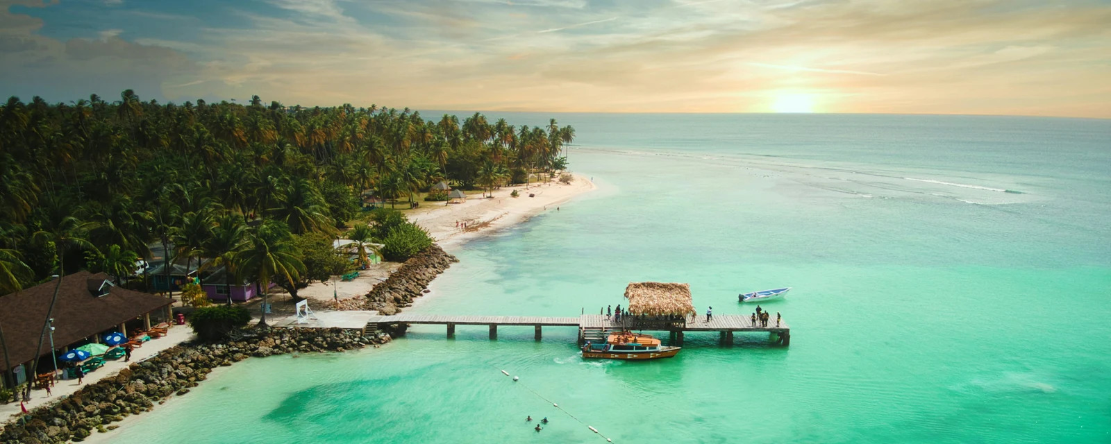 The thatched jetty and turquoise shallows at Pigeon Point Beach in Tobago
