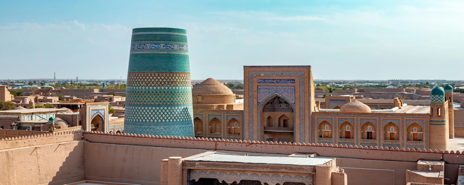 Turquoise Kalta Minor minaret and historic madrasa in Khiva, Uzbekistan
