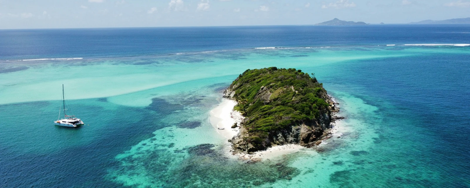 Jamesby island surrounded by clear turquoise reefs in Tobago Cays, Saint Vincent and the Grenadines